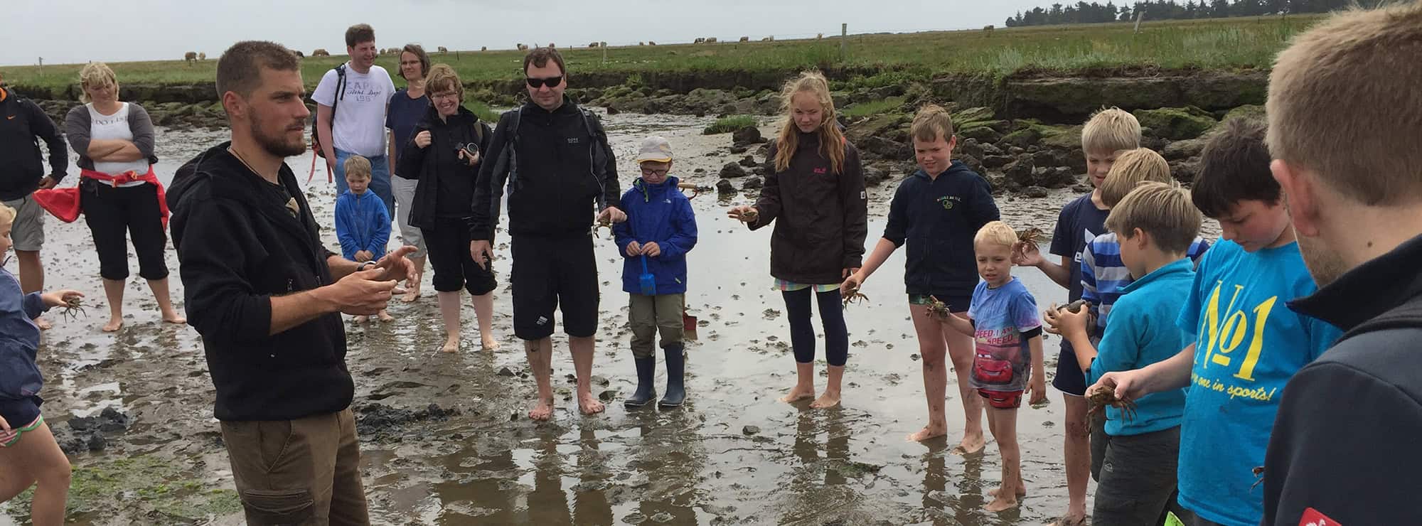 A group of people standing on a beach next to each other